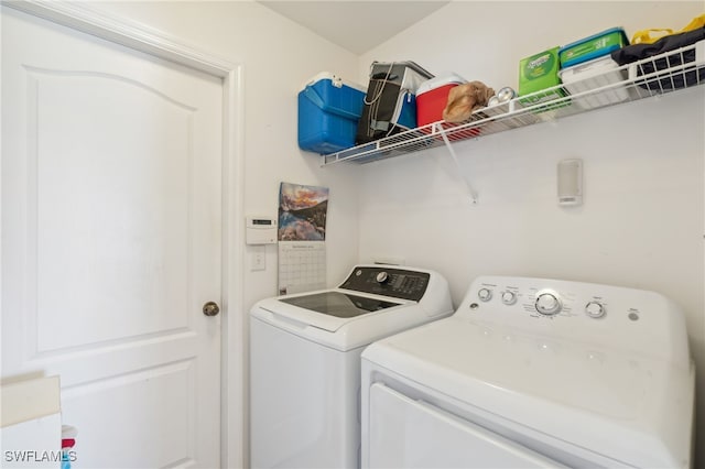 clothes washing area with washing machine and dryer