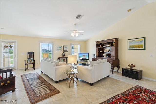 tiled living room featuring vaulted ceiling and ceiling fan