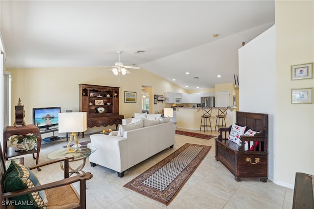 living room with ceiling fan and vaulted ceiling