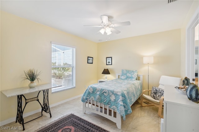 tiled bedroom featuring ceiling fan