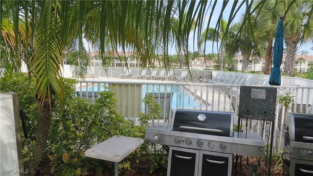 exterior space featuring a community pool and a grill