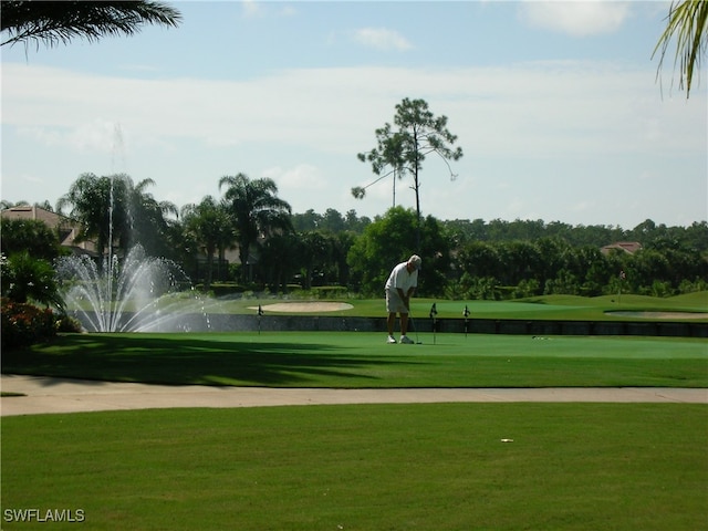 view of property's community with a water view and a yard