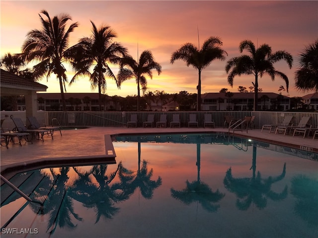 view of pool at dusk