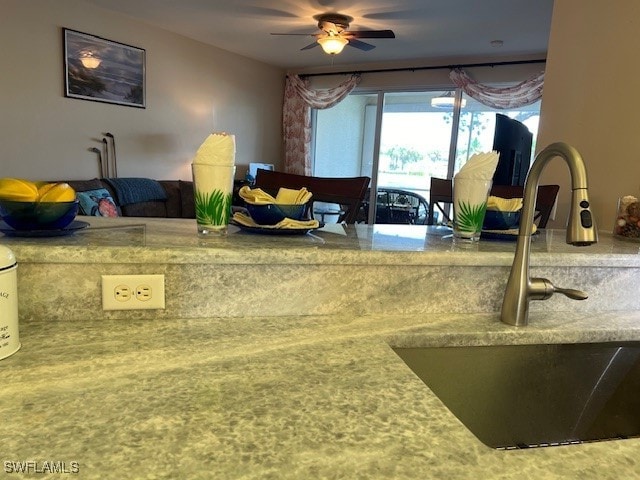 interior space featuring ceiling fan and sink