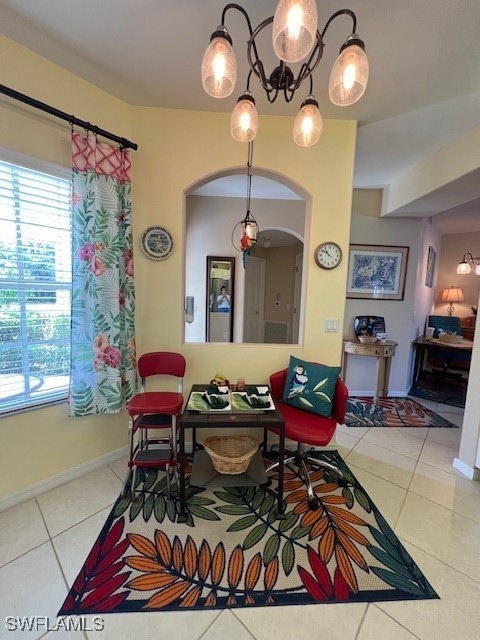 dining space featuring tile patterned flooring and a healthy amount of sunlight