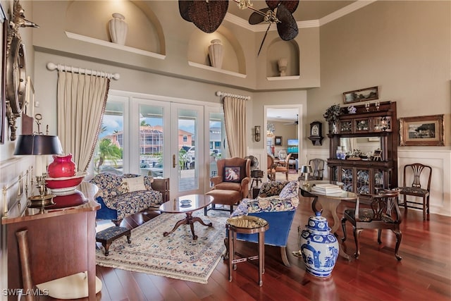 living room featuring ceiling fan, french doors, dark wood-type flooring, and a high ceiling