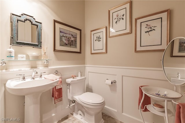 bathroom with toilet and tile patterned flooring