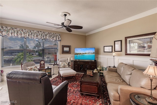 living room with ceiling fan and ornamental molding