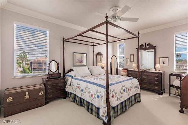 carpeted bedroom with ceiling fan, crown molding, and multiple windows