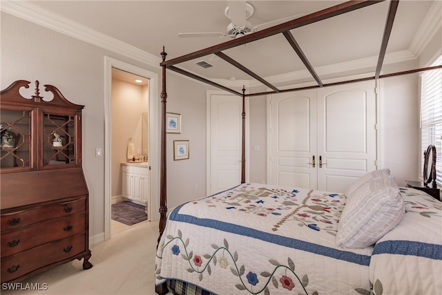 carpeted bedroom featuring a closet, ceiling fan, connected bathroom, and ornamental molding