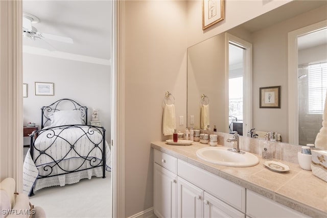 bathroom featuring ceiling fan, crown molding, and vanity