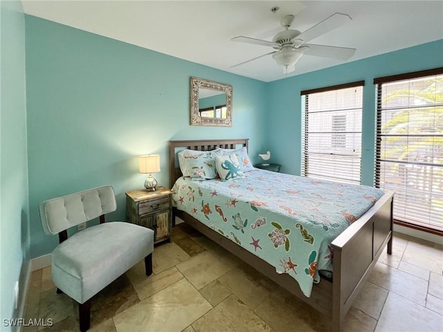 bedroom featuring ceiling fan and baseboards
