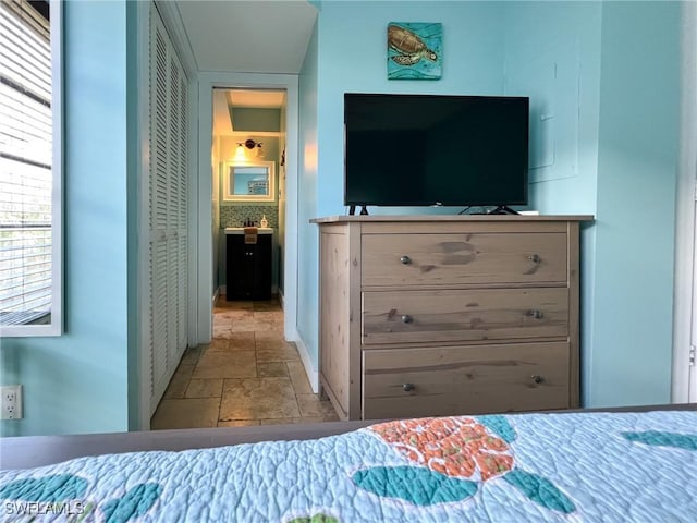 bedroom featuring stone tile flooring