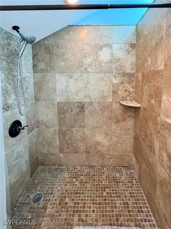 bathroom with tiled shower