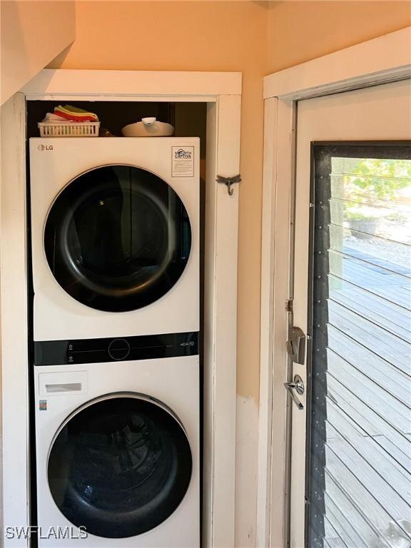 laundry room featuring stacked washer / drying machine