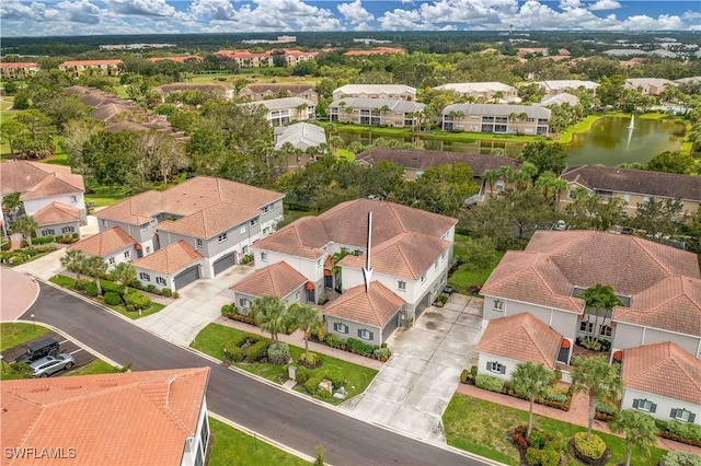 drone / aerial view with a water view and a residential view