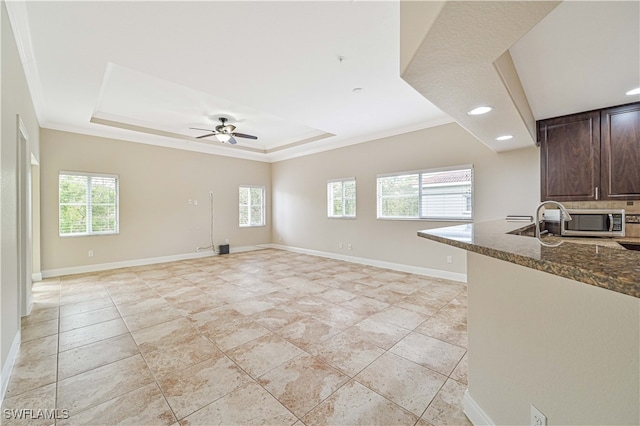 interior space featuring crown molding, plenty of natural light, and ceiling fan