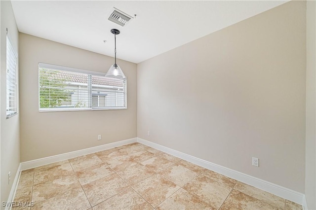 spare room featuring visible vents and baseboards