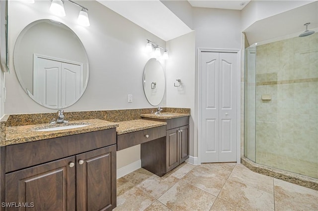 bathroom featuring a closet, a sink, a shower stall, and double vanity