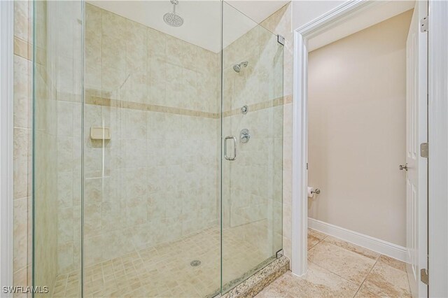 bathroom with tile patterned flooring and walk in shower