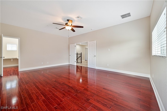 unfurnished room with dark wood-type flooring and ceiling fan