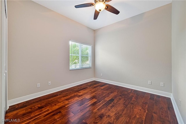 unfurnished room featuring dark wood-style floors, baseboards, and a ceiling fan