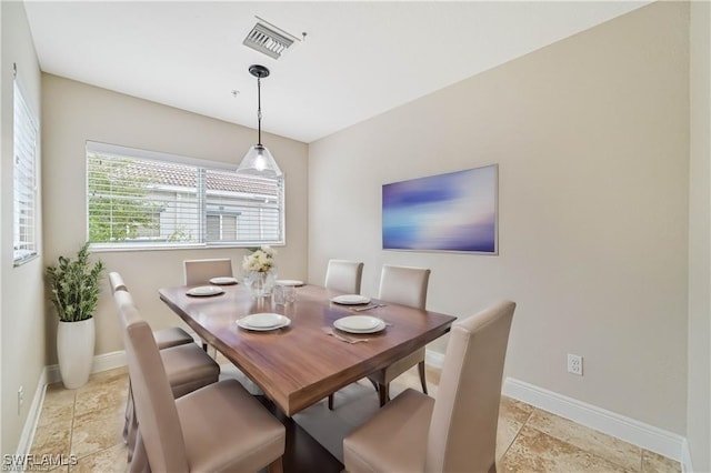 dining room featuring baseboards and visible vents