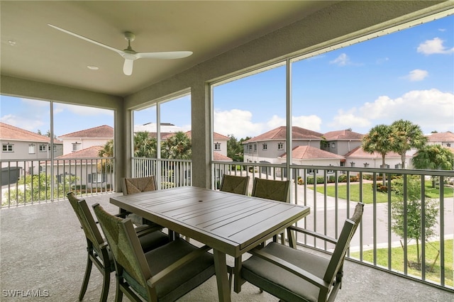 sunroom / solarium featuring ceiling fan