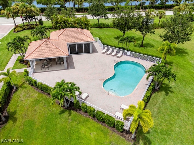 view of swimming pool with a patio area and a yard