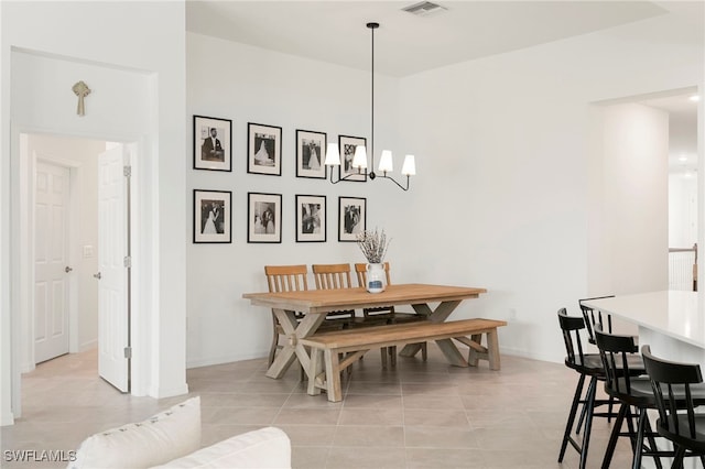 dining space with light tile patterned floors and an inviting chandelier