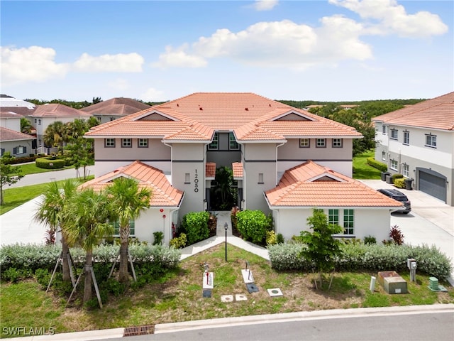 mediterranean / spanish-style home with a garage