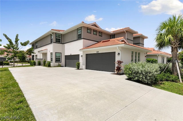 mediterranean / spanish home featuring a garage