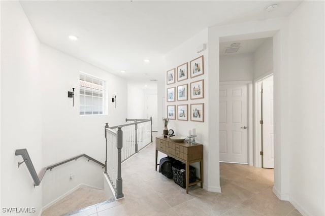 corridor featuring light tile patterned floors