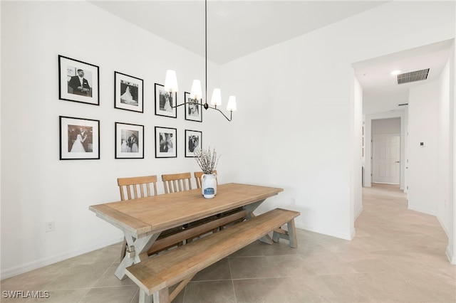 dining area featuring a chandelier and tile patterned floors