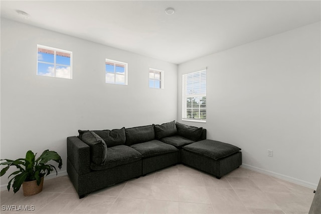 tiled living room featuring a healthy amount of sunlight