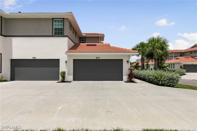 mediterranean / spanish-style home featuring a garage