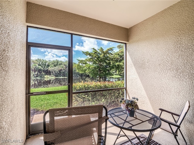 unfurnished sunroom with a water view