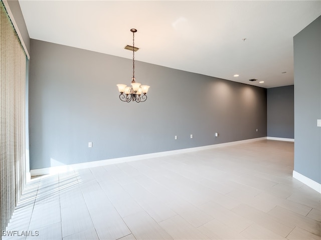 spare room with a chandelier