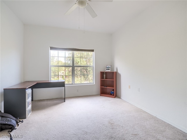 unfurnished office with ceiling fan and carpet floors