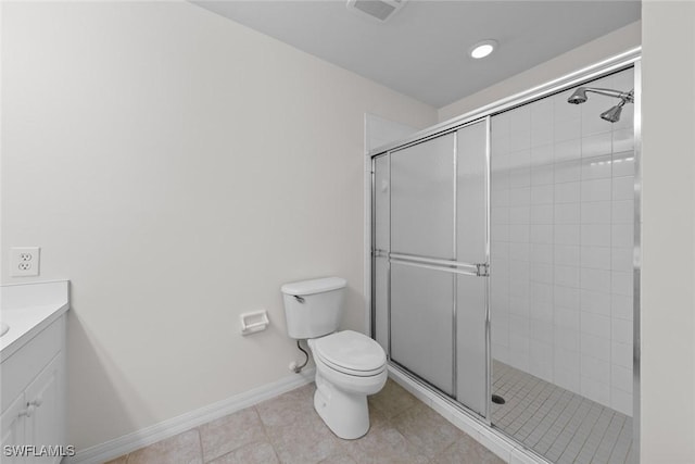 bathroom featuring toilet, a shower stall, vanity, and tile patterned floors