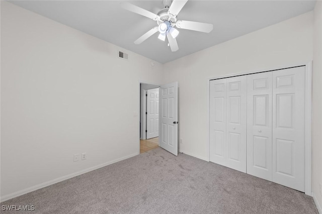 unfurnished bedroom with ceiling fan, carpet flooring, visible vents, baseboards, and a closet