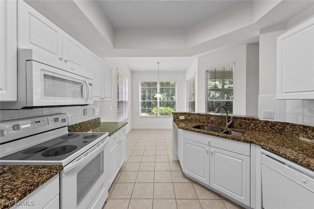 kitchen featuring white appliances, light tile patterned floors, white cabinetry, and a sink