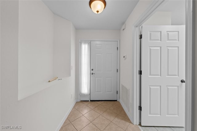 entryway featuring light tile patterned flooring, visible vents, and baseboards