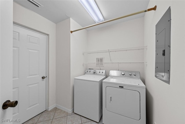 washroom featuring laundry area, electric panel, independent washer and dryer, and light tile patterned floors