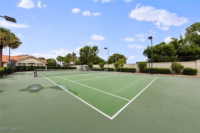 view of tennis court featuring fence