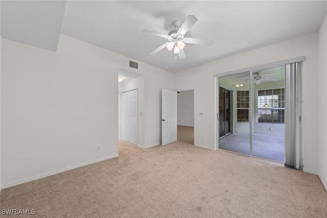 unfurnished bedroom with light carpet, access to outside, visible vents, and baseboards