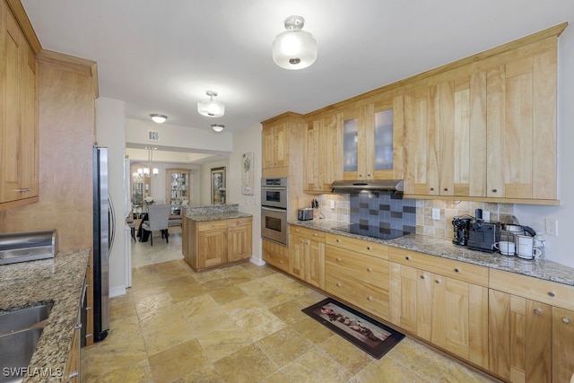 kitchen with wall chimney exhaust hood, tasteful backsplash, light stone counters, light tile patterned floors, and stainless steel appliances