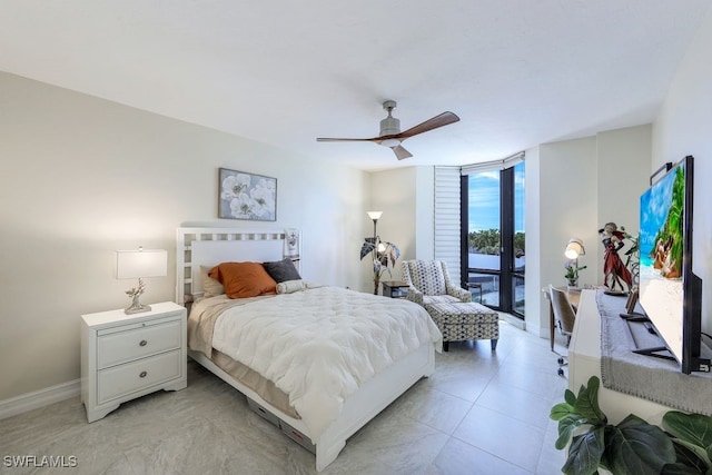 bedroom featuring a wall of windows, ceiling fan, light tile patterned floors, and access to outside