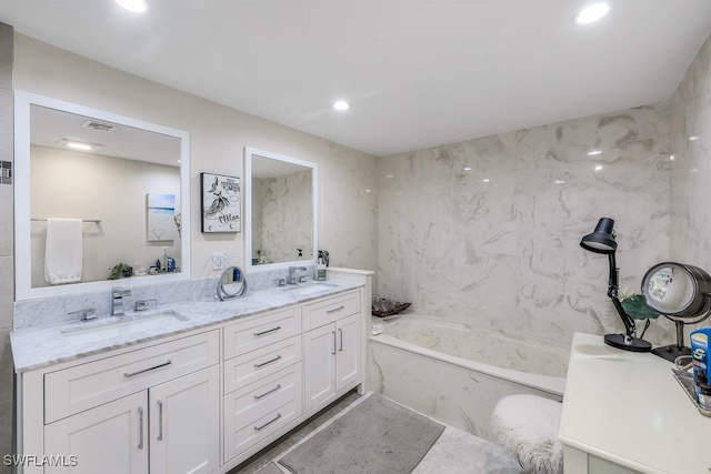 bathroom featuring a bath and vanity