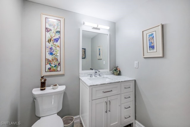 bathroom featuring toilet and vanity